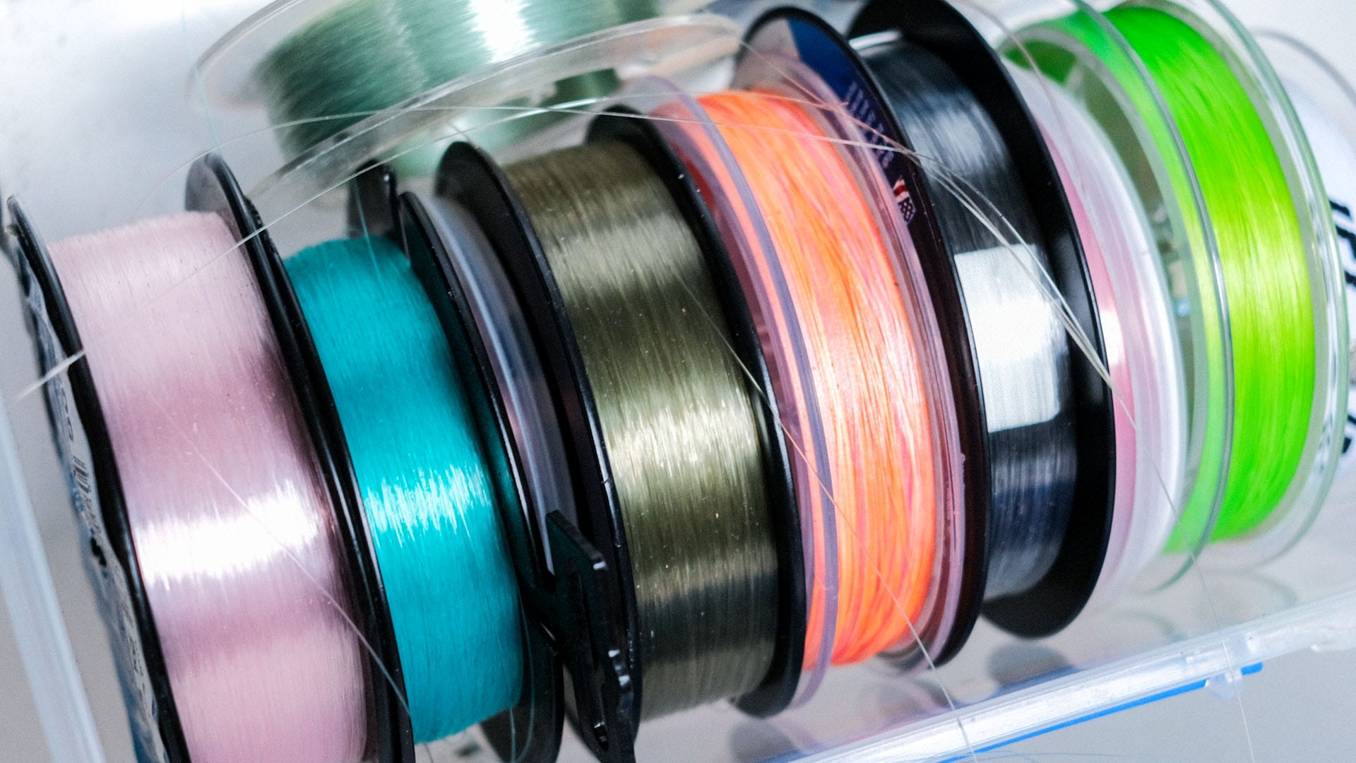 A container of different fishing line spools stacked together
