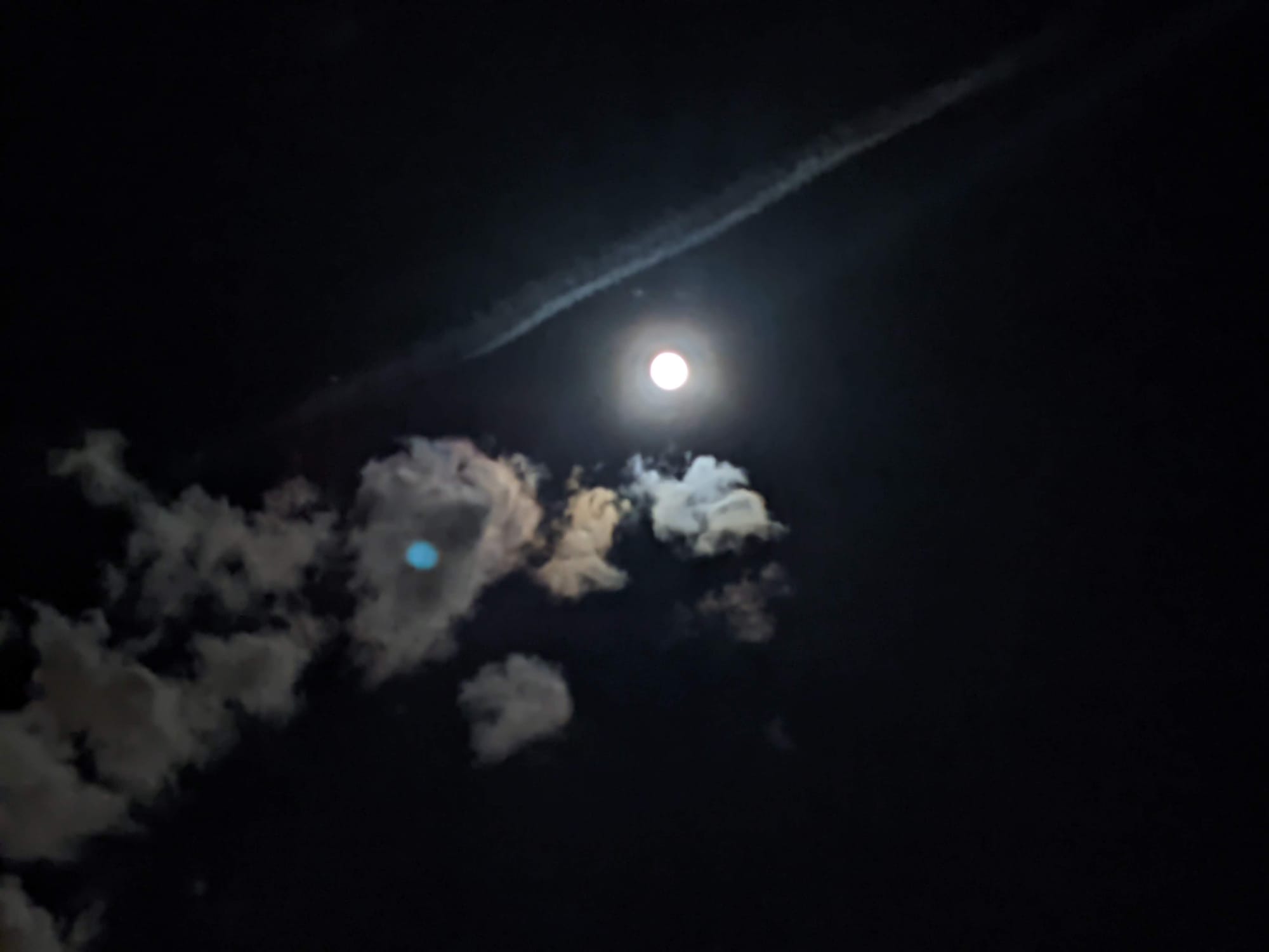full moon, dark sky, scattered cumulus clouds