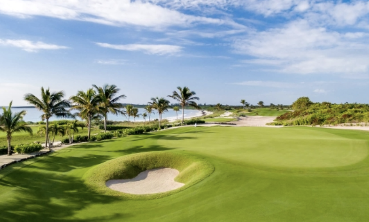 Experience the tranquil setting of the championship golf course at the Abaco Club, framed by palm trees and verdant shrubbery.&nbsp;