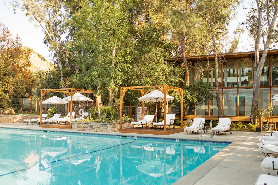 Experience this serene wellness retreat that blends modern elegance with nature’s embrace around the pristine spa pool.