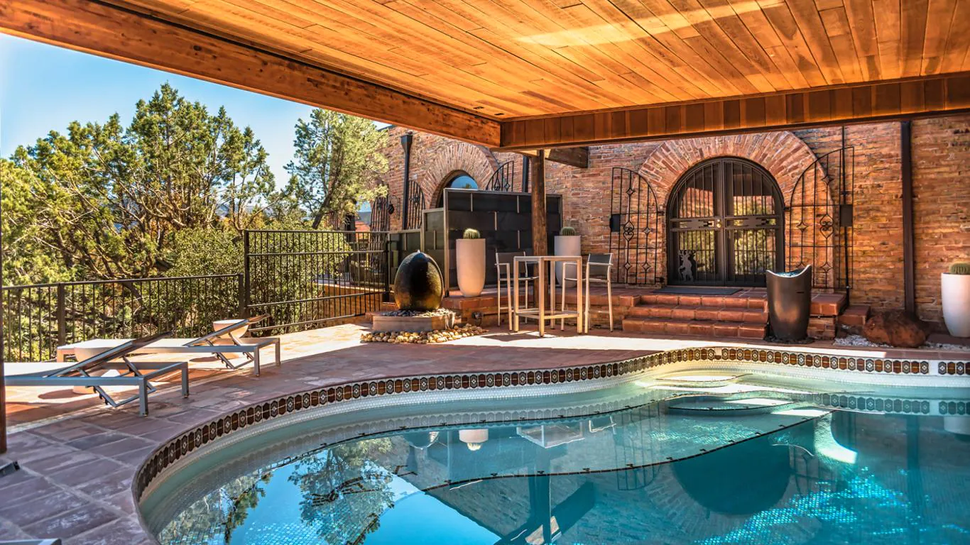 Sedona’s secluded luxury retreat is framed by rustic brick archways and complete with a serene swimming pool.