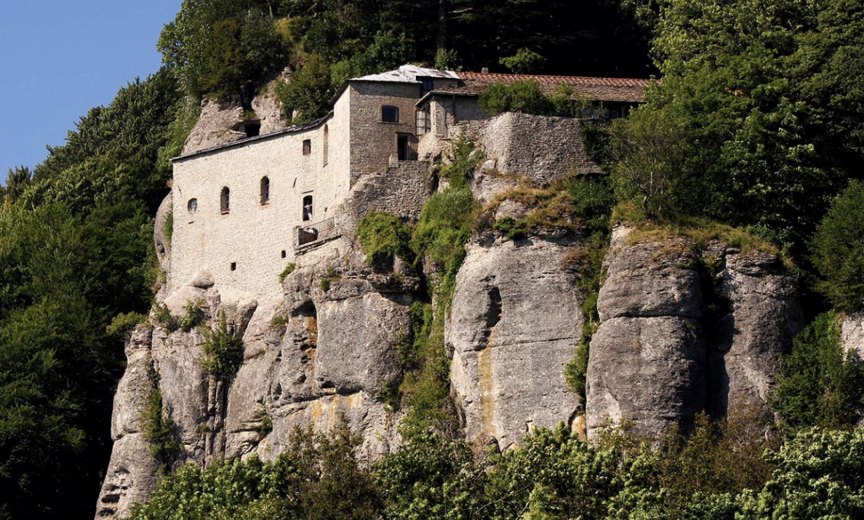 A stunning view of La Verna Sanctuary in Arezzo, nestled in the Apennines, surrounded by lush greenery and offering a serene, spiritual atmosphere.