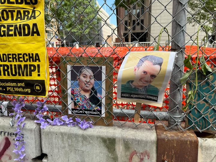 In front of a Manhattan ICE office, a fence is covered in photos of vanished immigrants