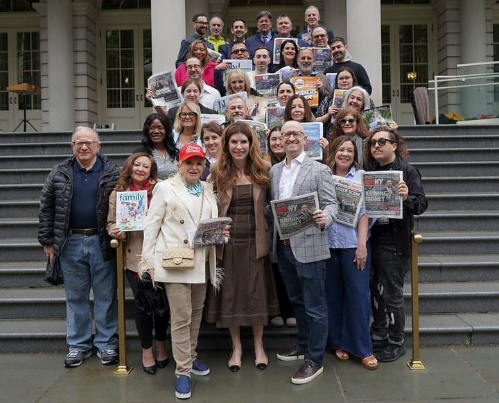 City Council Speaker Julie Menin stands with employees of Schneps Media on the steps of City Hall in May.