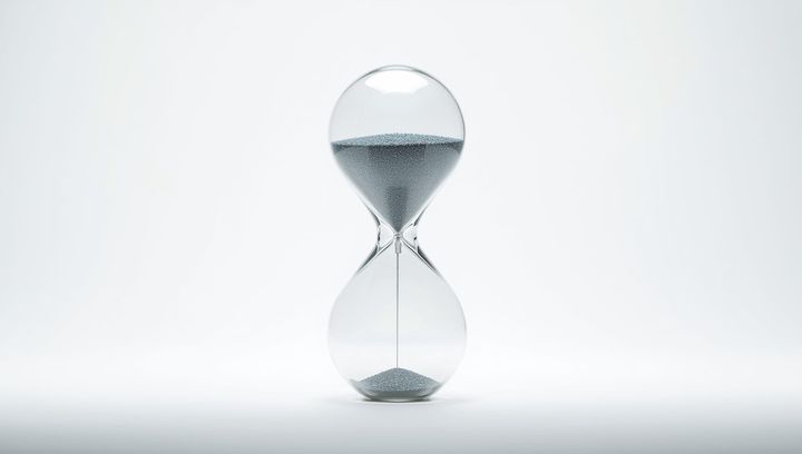 A modern, perfectly clear glass hourglass.