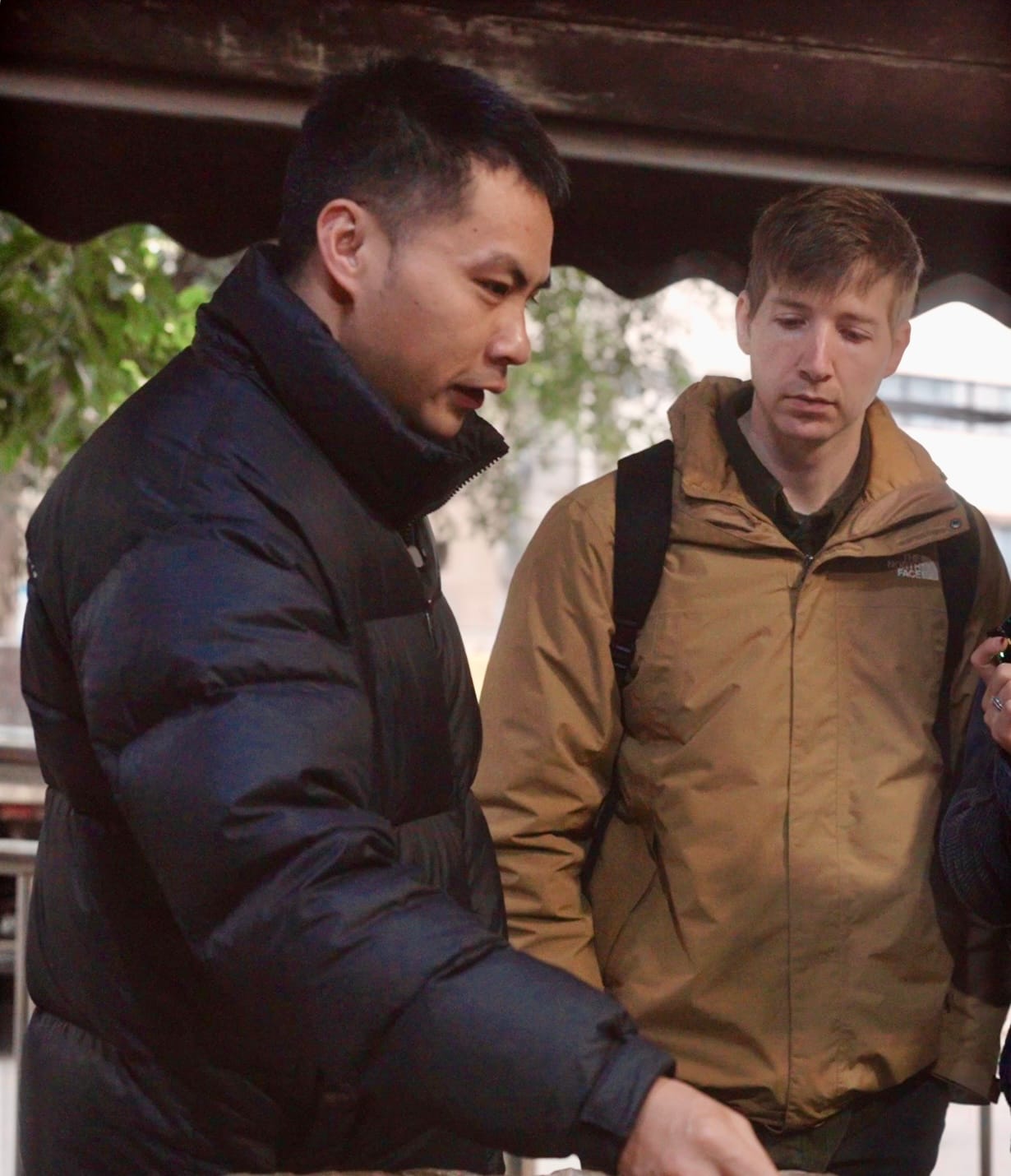 Chef Tang Bo sharing insights, speaking to and standing next to another gentleman.