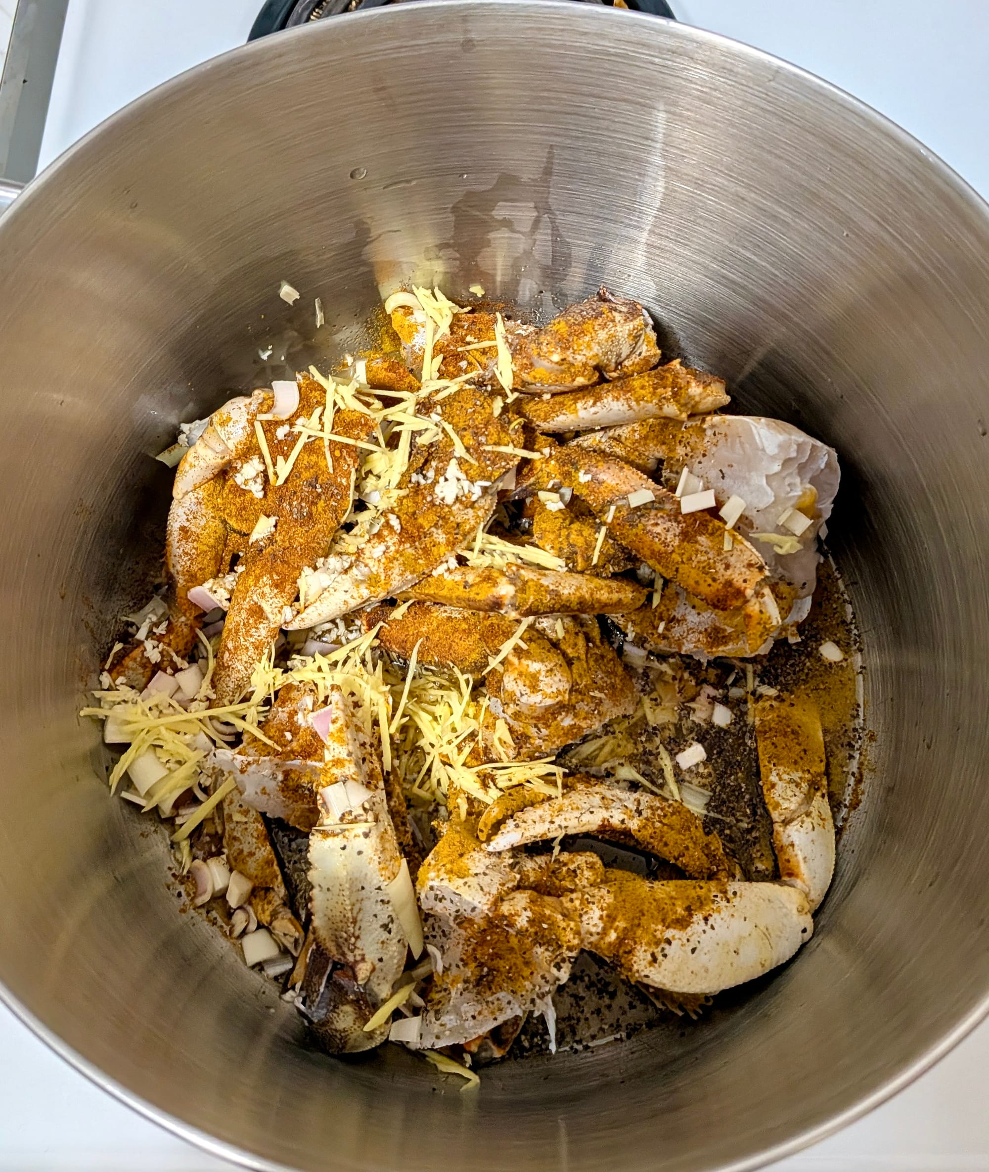Mixed spices and crab meat in a pot before water is added to boil.
