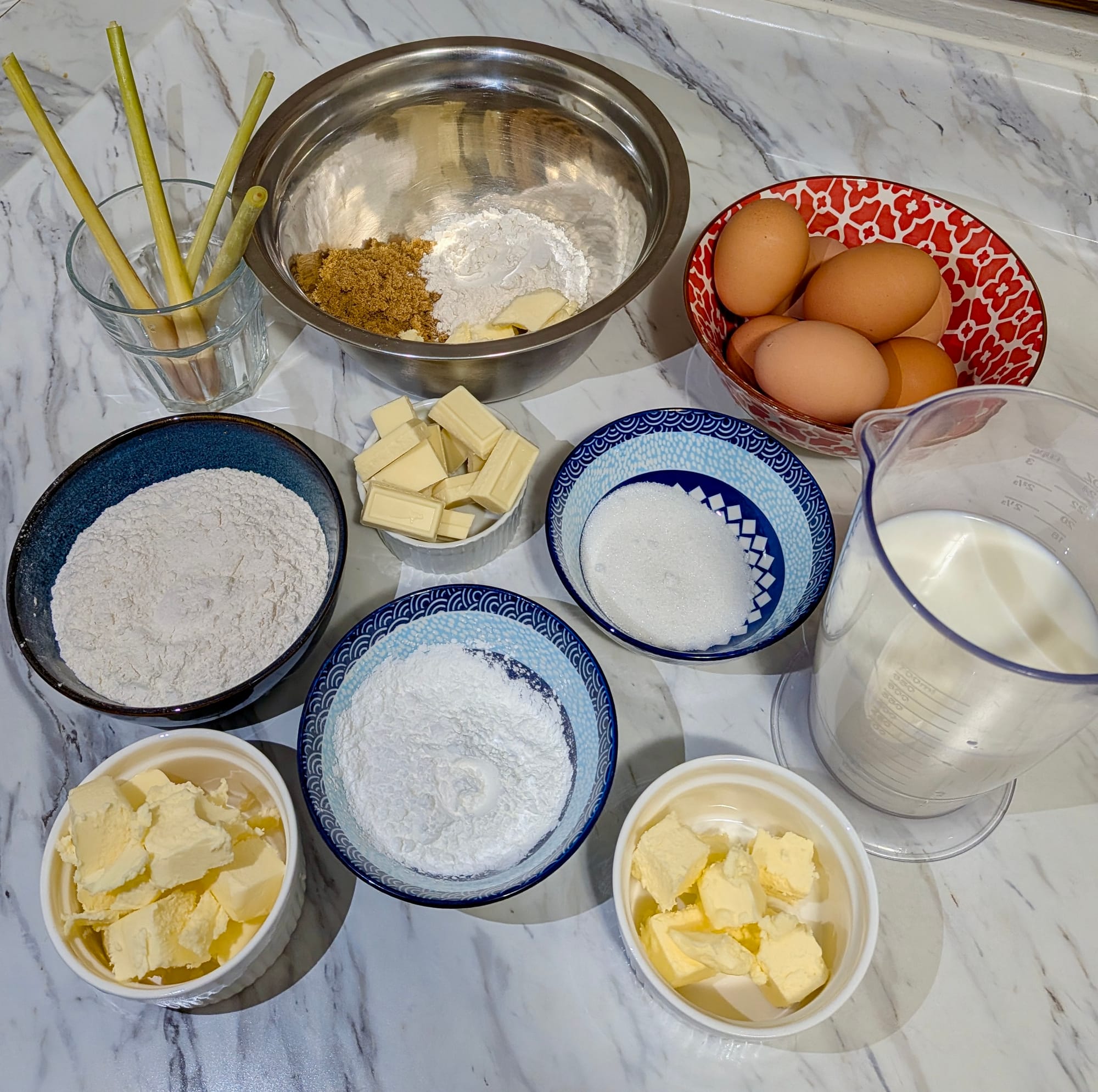 Portioned ingredients for Lemongrass Petite Choux in dishes on a counter.