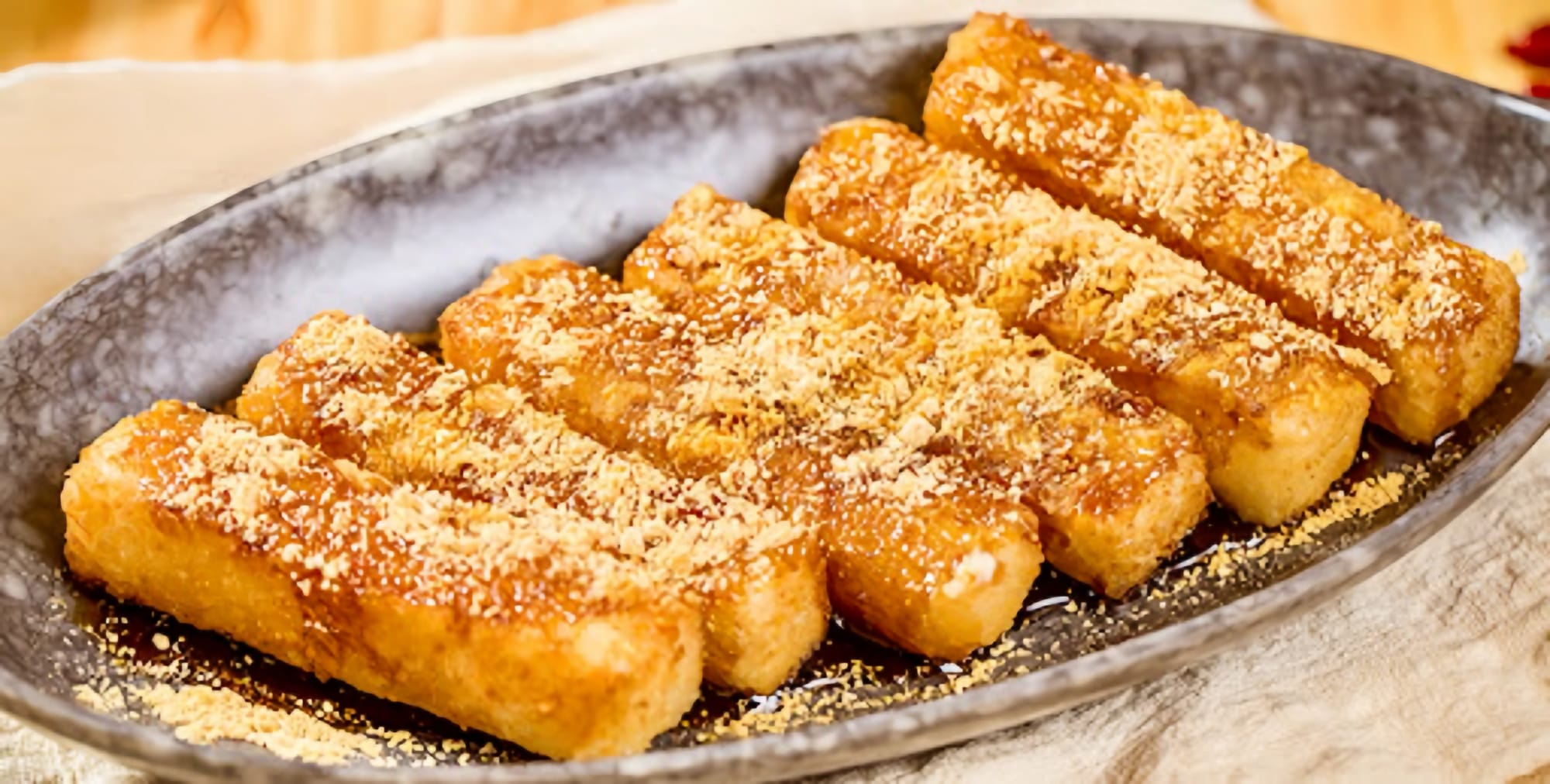 Six pieces of Brown Sugar Ciba on a slate dish.