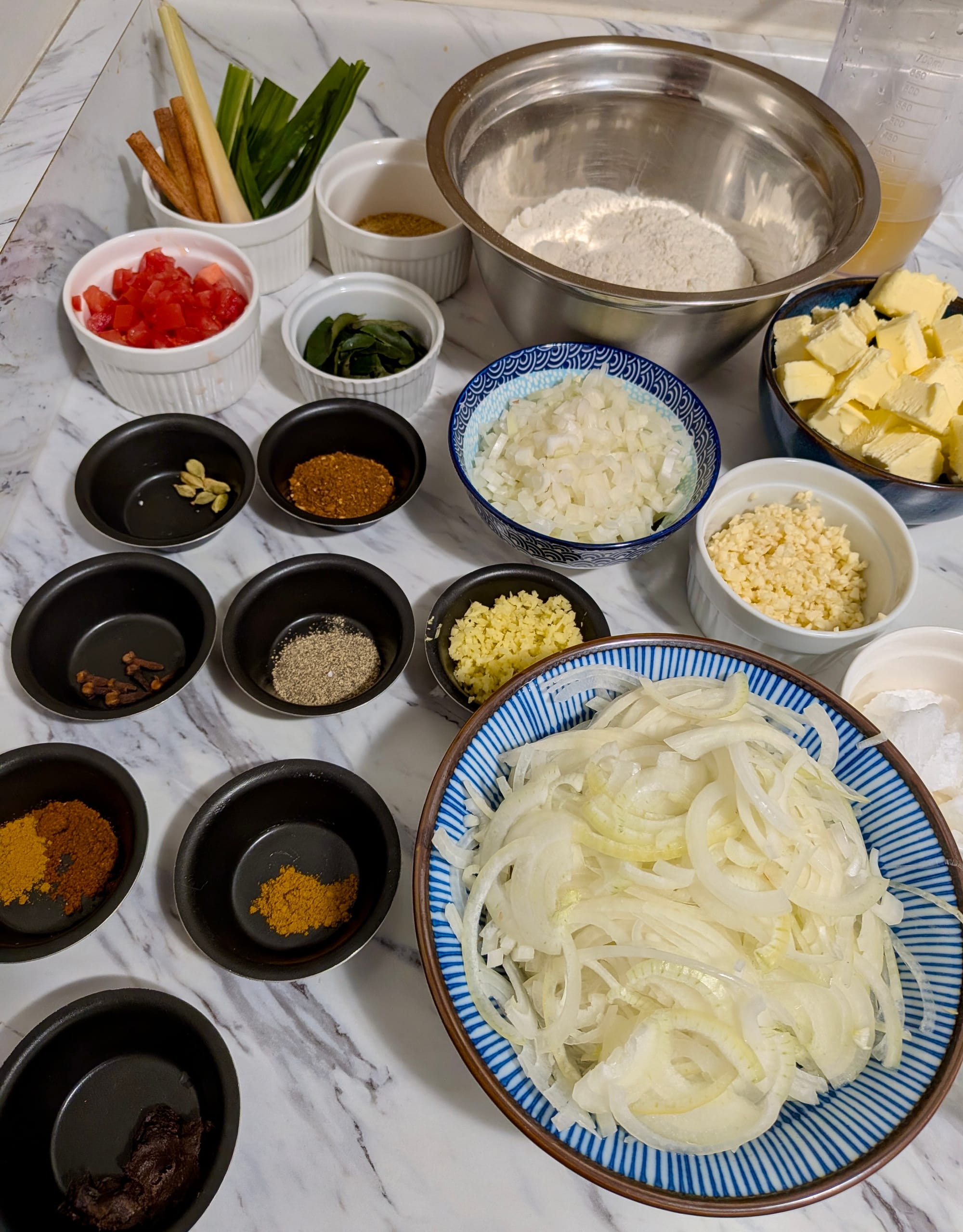 Portioned ingredients for Sri Lankan Chicken Curry Pithivier on a counter.