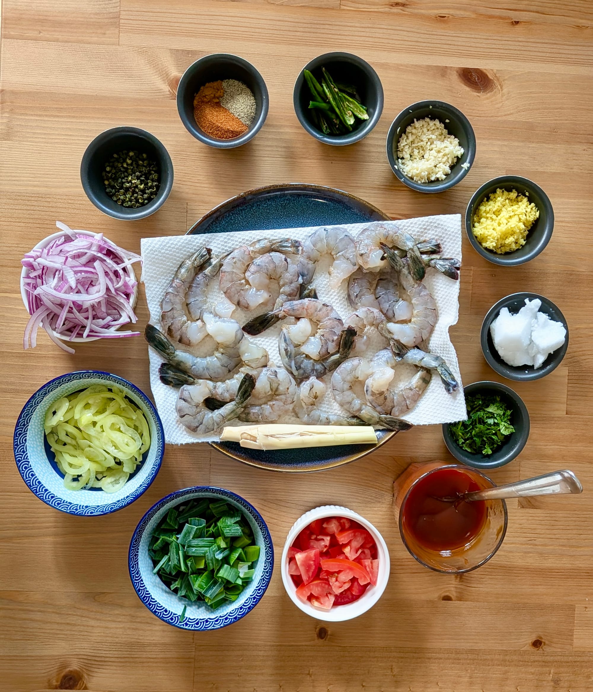 The ingredients spread, all portioned and in their individual little dishes, for the dish of Mala Devilled Prawns.