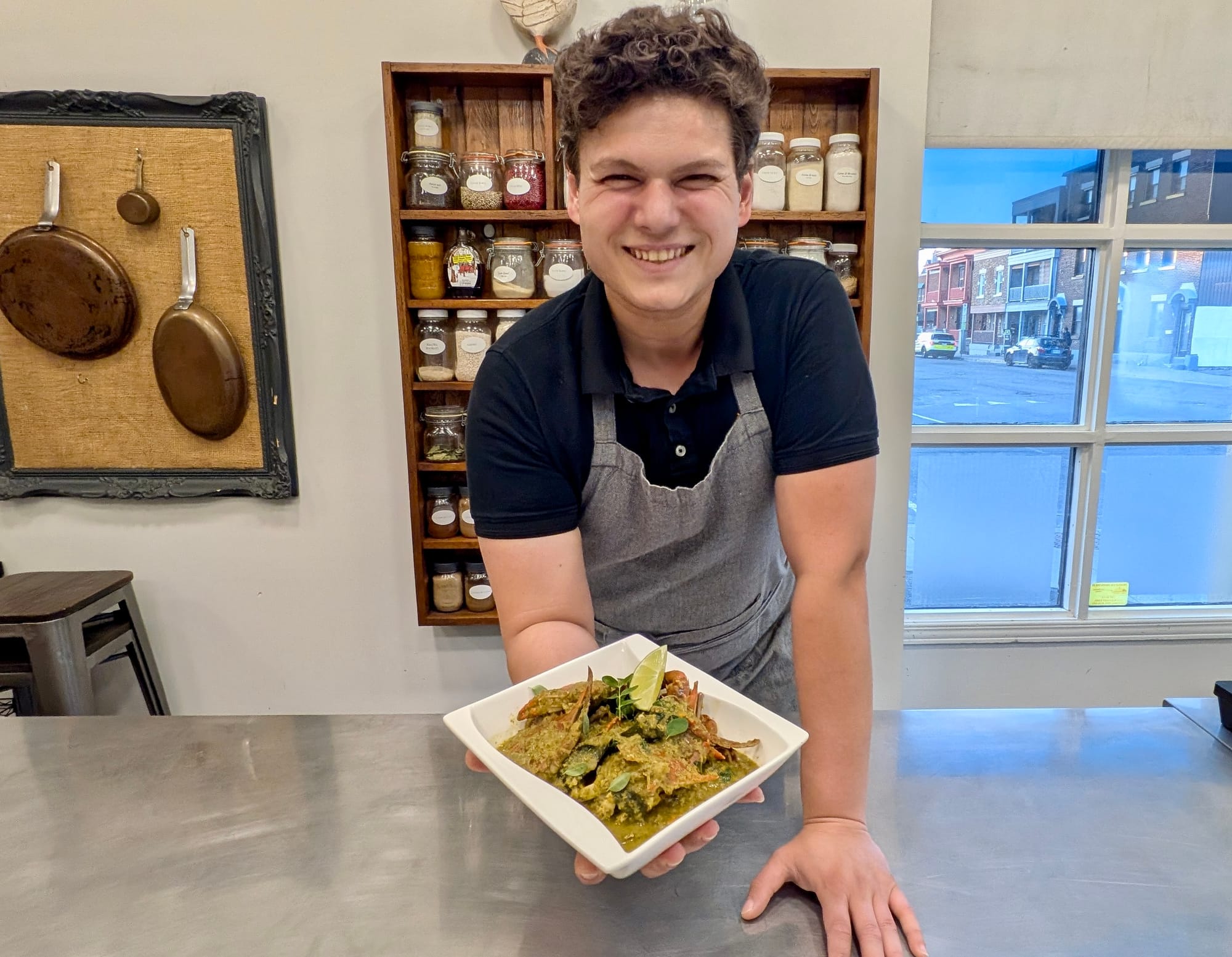 Chef Arnold Kuiper presents his Crab Curry - a green sauce with chunks of crab and vegetables with a wedge of lime.