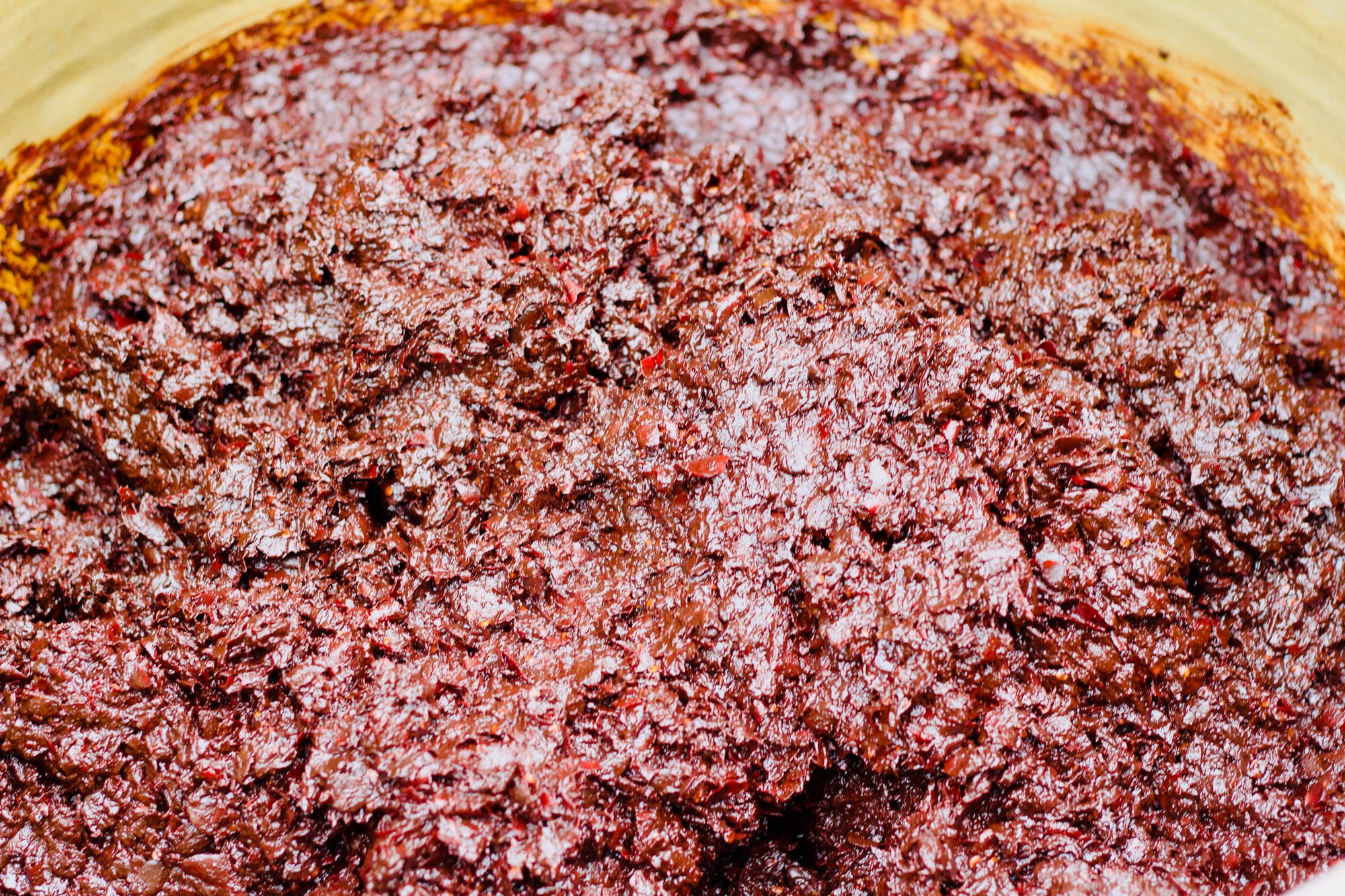 A close-up photo of red-brown doubanjiang; a mashed fermented bean dish.