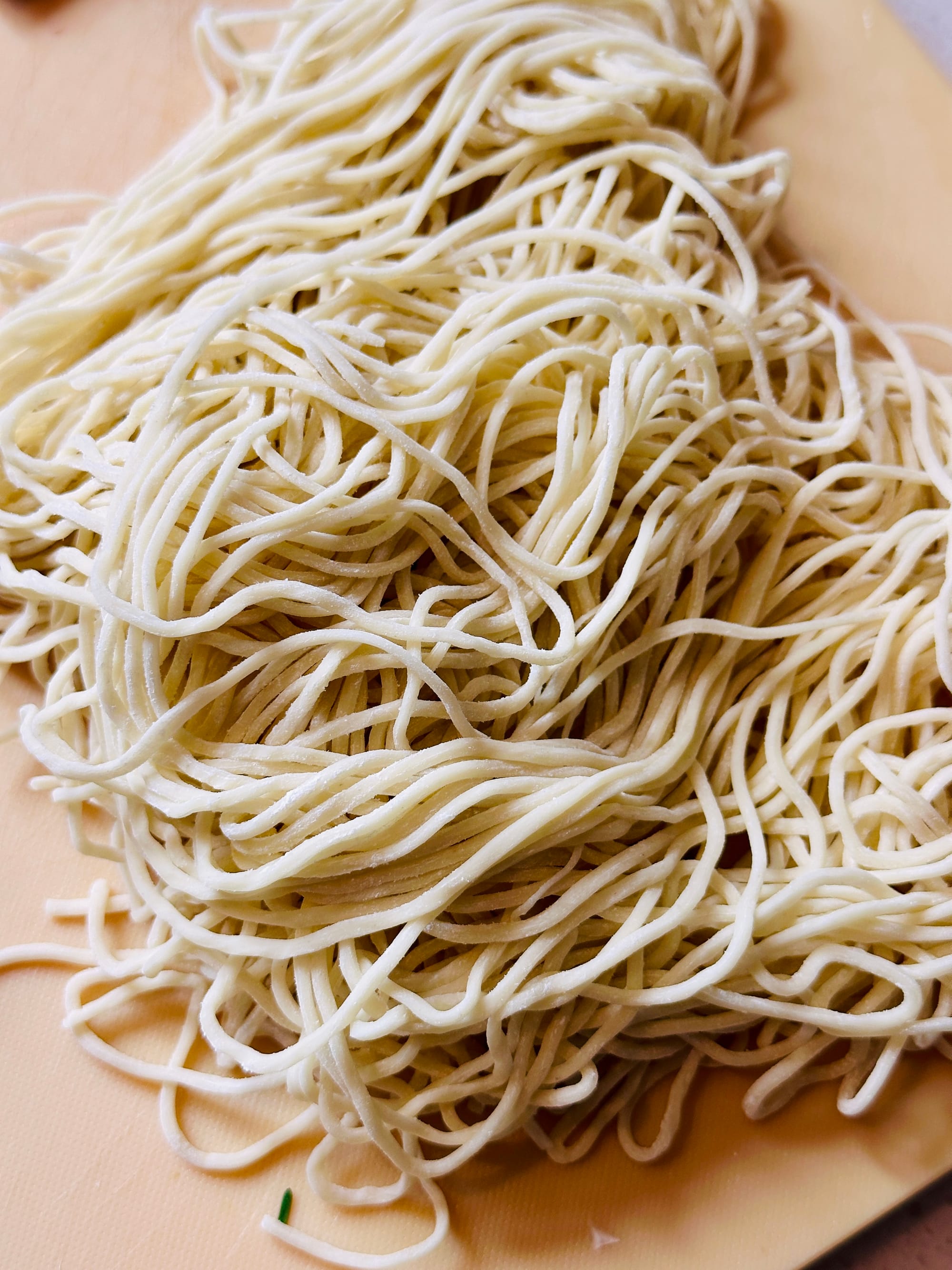 Shanghai noodles in a bunch, lightly coated in flower.