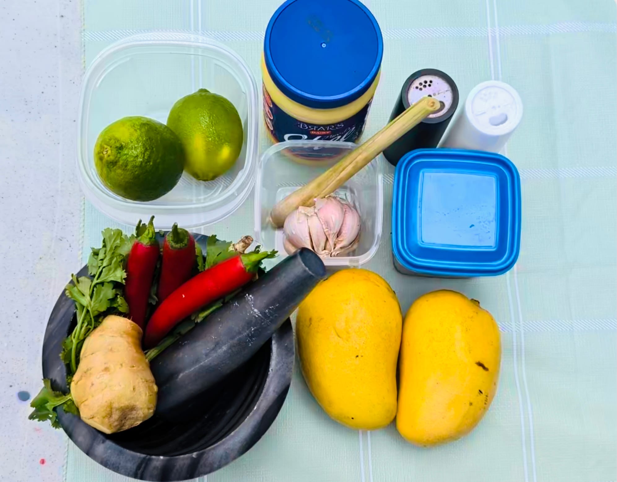 A portioned ingredient spread for grilled prawn skewers with mango achcharu