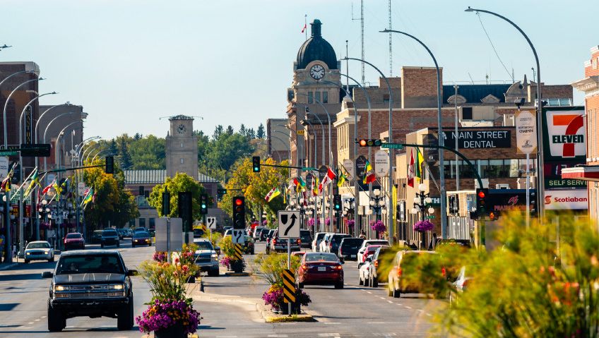 Downtown moosejaw - a main road with quaint brick buildings and minimal traffic.