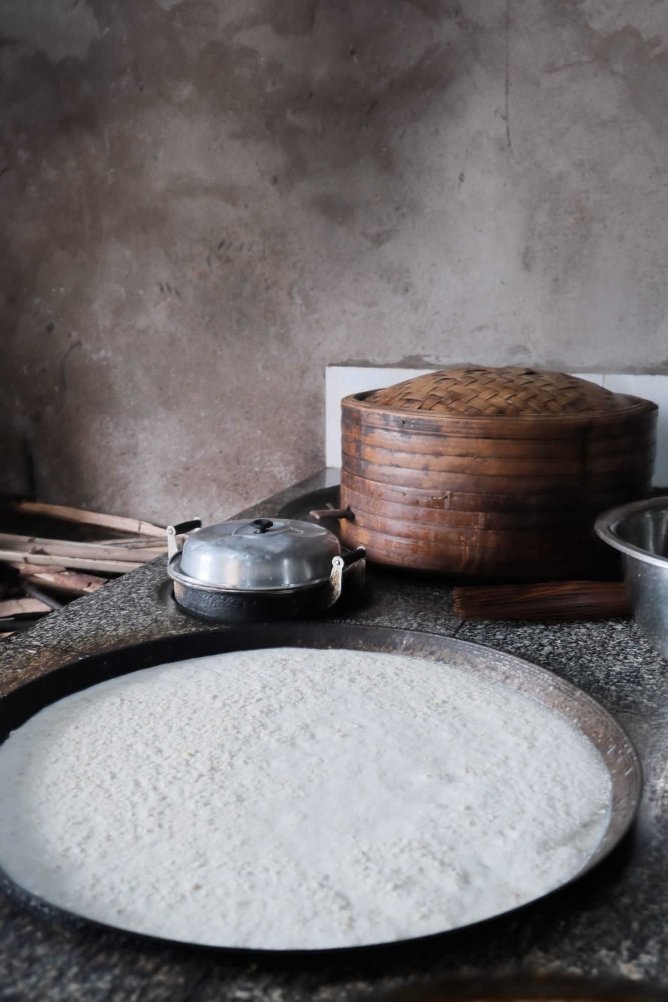 Lu Shui, a white coagulant used in Chinese tofu on a large traditional cooking top.
