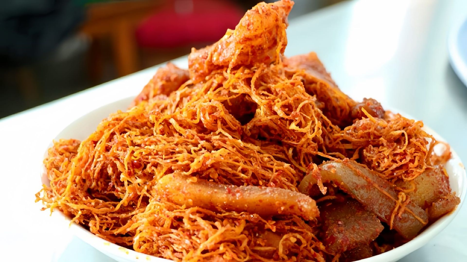 Shredded radish and fermented fish in a white bowl.