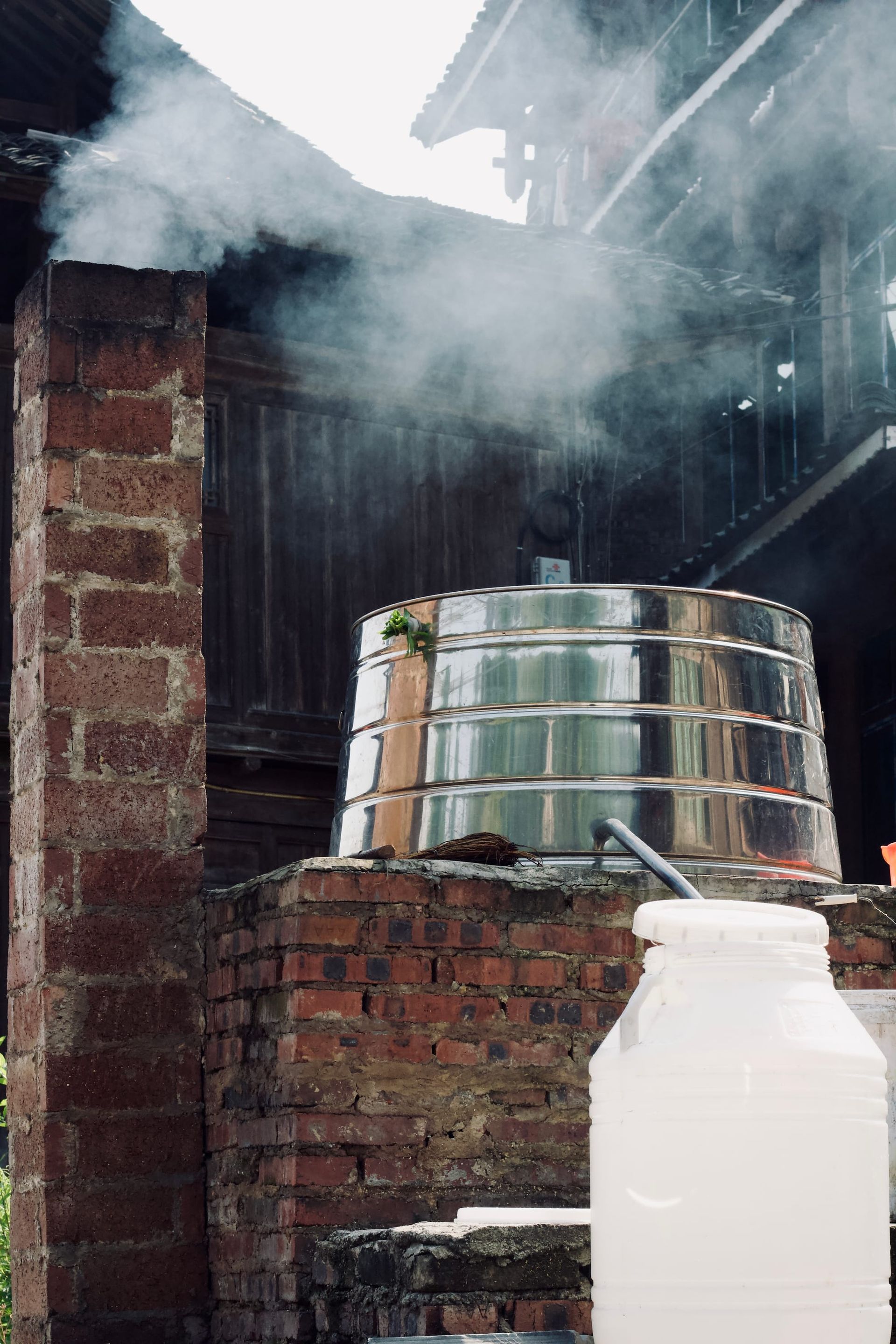 Traditional Dong rice wine distillation vat shrouded in brick.