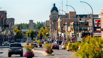 Downtown moosejaw - a main road with quaint brick buildings and minimal traffic.