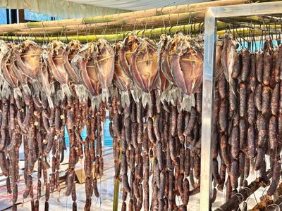 Sichuan winter sausages dry by the dozen along with dried fish hanging from bamboo trusses. 