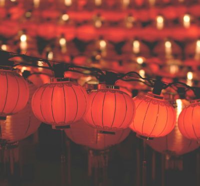 Glowing red Chinese lanterns in a row.