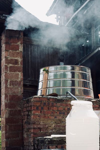 Traditional Dong rice wine distillation vat shrouded in brick.