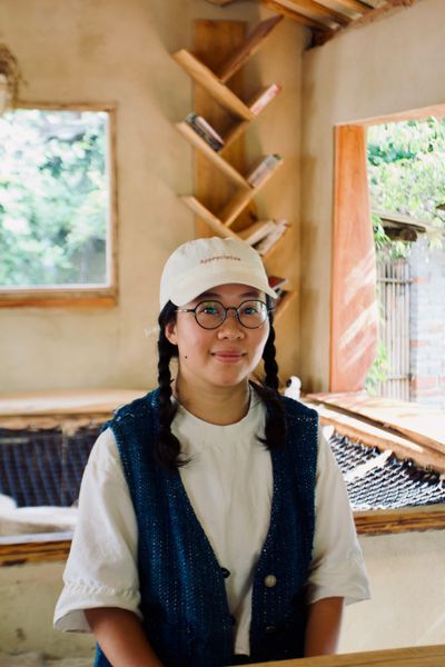 SanSan - the founder of Nature Bites in Guizhou, China sits at the bar in her small cafe.
