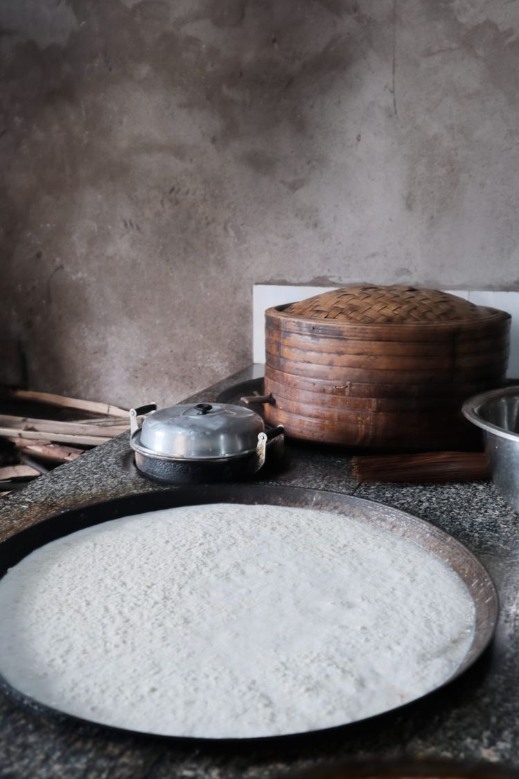 Lu Shui, a white coagulant used in Chinese tofu on a large traditional cooking top.