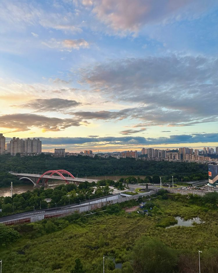 The modern sprawl of Luzhou, flanking the Yangtze river with a simple modern arch-style bridge connecting two sections of the city.
