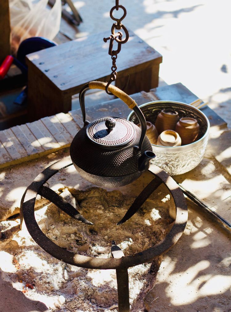 Tea pot hanging over a fire pit