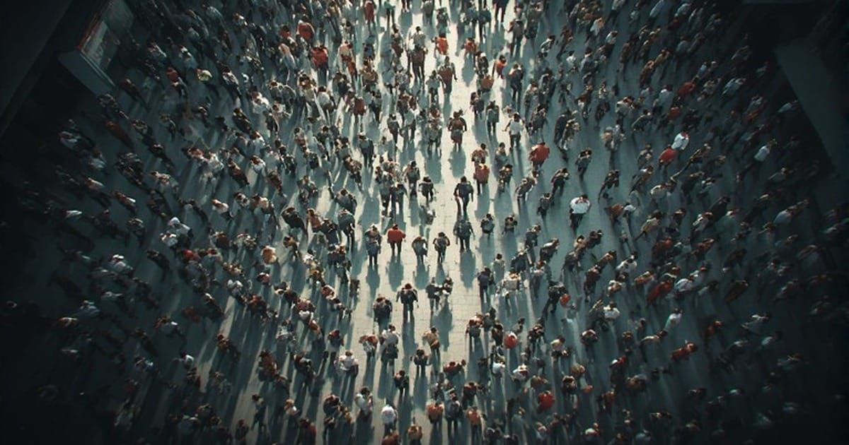 Aerial overhead view of a large dispersed crowd walking through an open public space