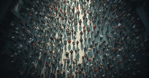 Aerial overhead view of a large dispersed crowd walking through an open public space