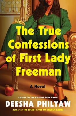 Cover of The True Confessions of First Lady Freeman by Deesha Philyaw featuring a Black woman in a stylish green pantsuit and heels seated with a wide stance; there is an apple at her feet and the image cuts off the top of her head