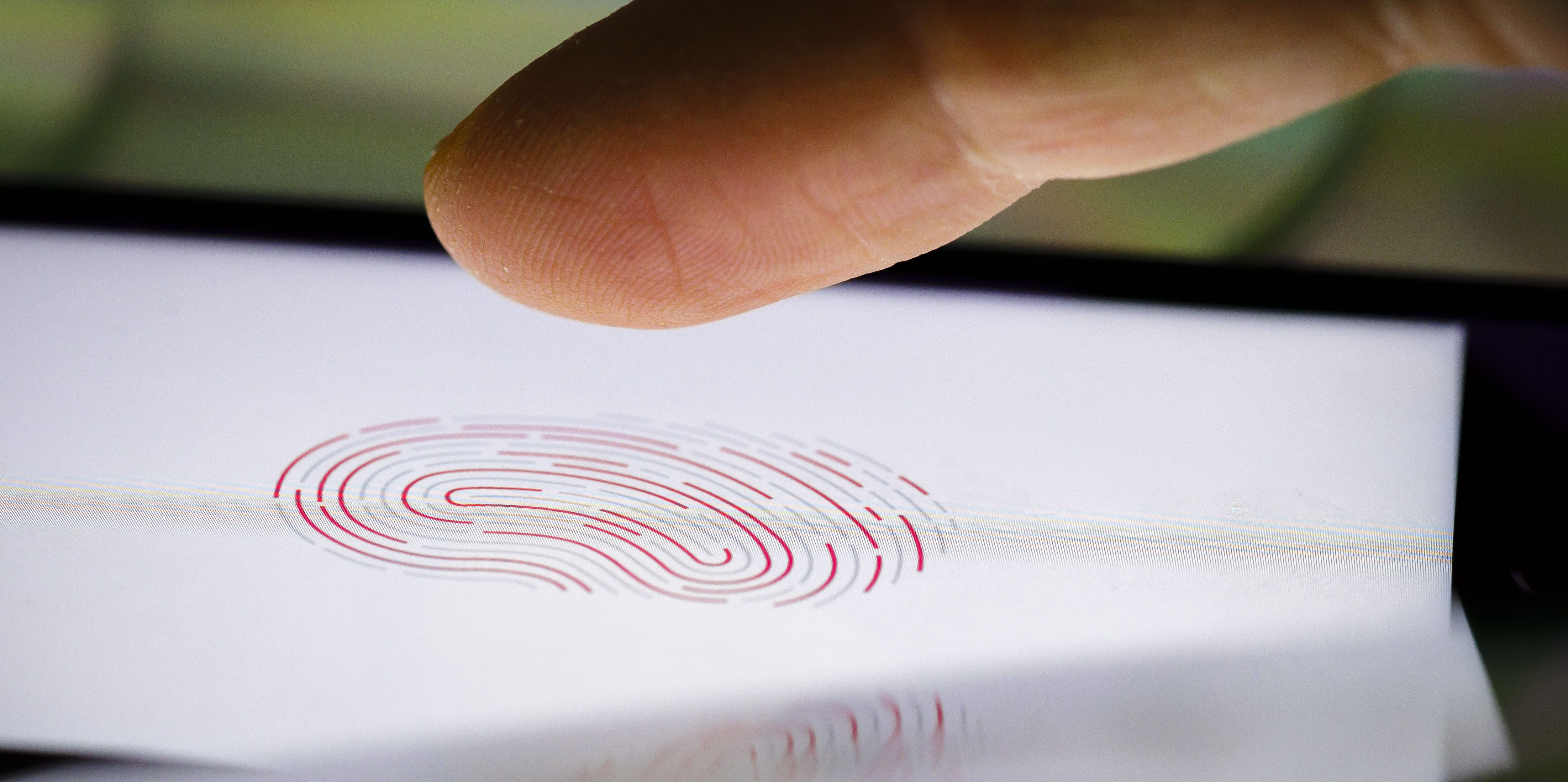 A finger hovers above an iPhone displaying an image of a fingerprint on February 18, 2020 in Berlin, Germany.