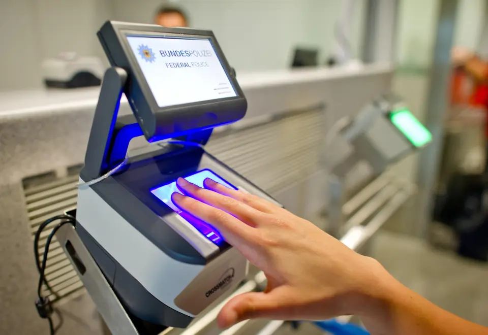 A female passenger places four fingers on a scanner of the 'Smart Border' border management system as it captures her fingerprints at the border checkpoint of the German police at the airport in Frankfurt/Main, Germany, 29 June 2015. The EU&nbsp;Commissi