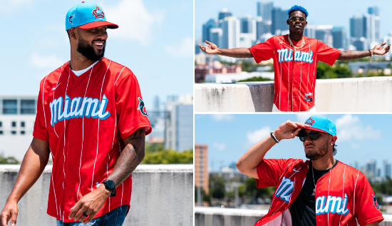 Bright red jersey with a widely-separated white pinstripe and the word "Miami" on the chest. The cap is teal with a red bill and a crown as the front-facing logo.