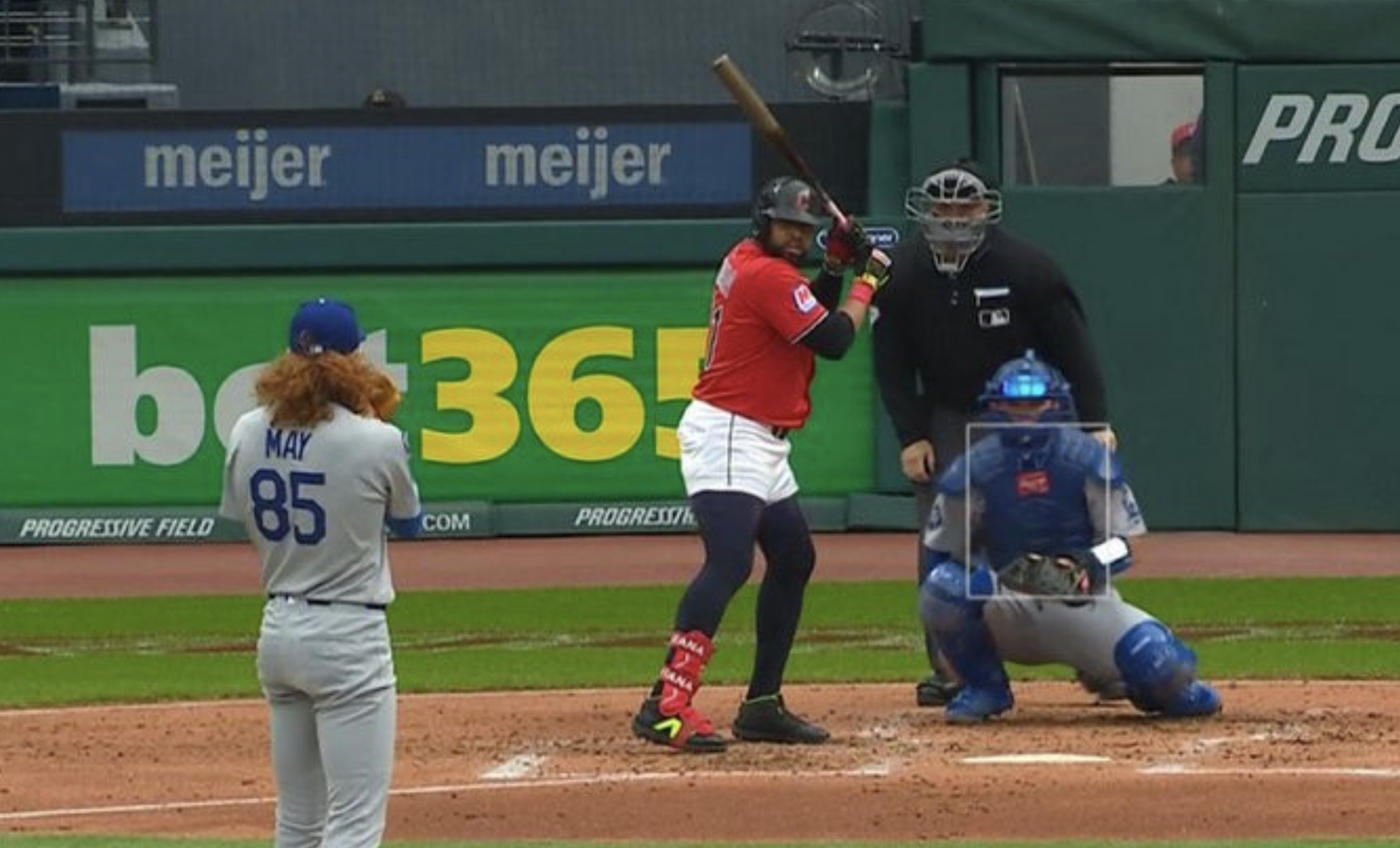 Dustin May is pitching to Carlos Santana who has his pants rolled up so high that they are wearing like shorts, underneath which he has on compression pants, which makes it look like he's wearing hot pants and tights. 