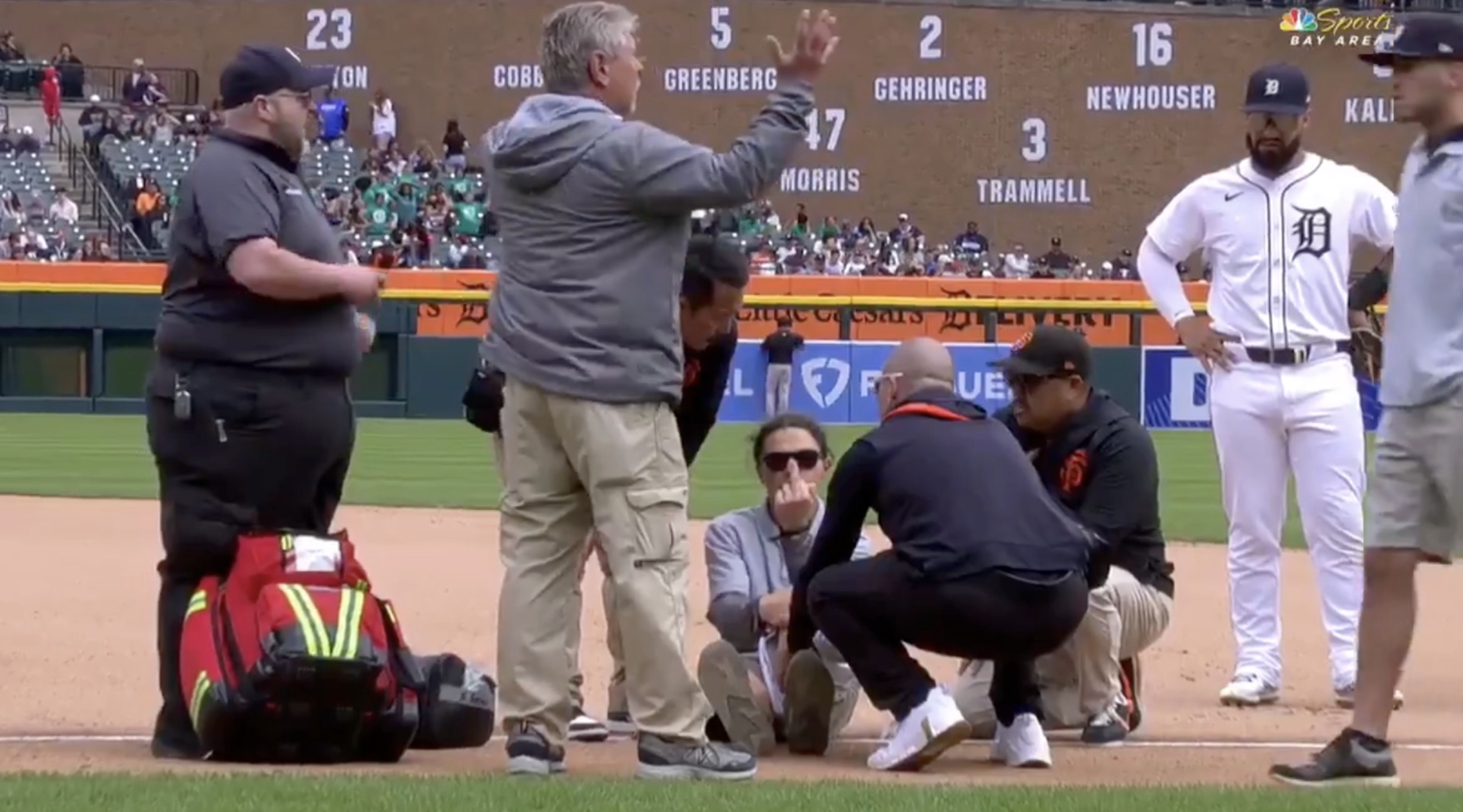 Grounds crew member injured on the ground giving the camera the middle finger.