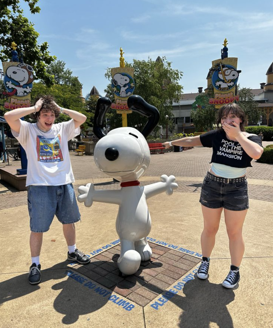 My grown-ass kids acting all excited at a Snoopy statue at Cedar Point amusement park