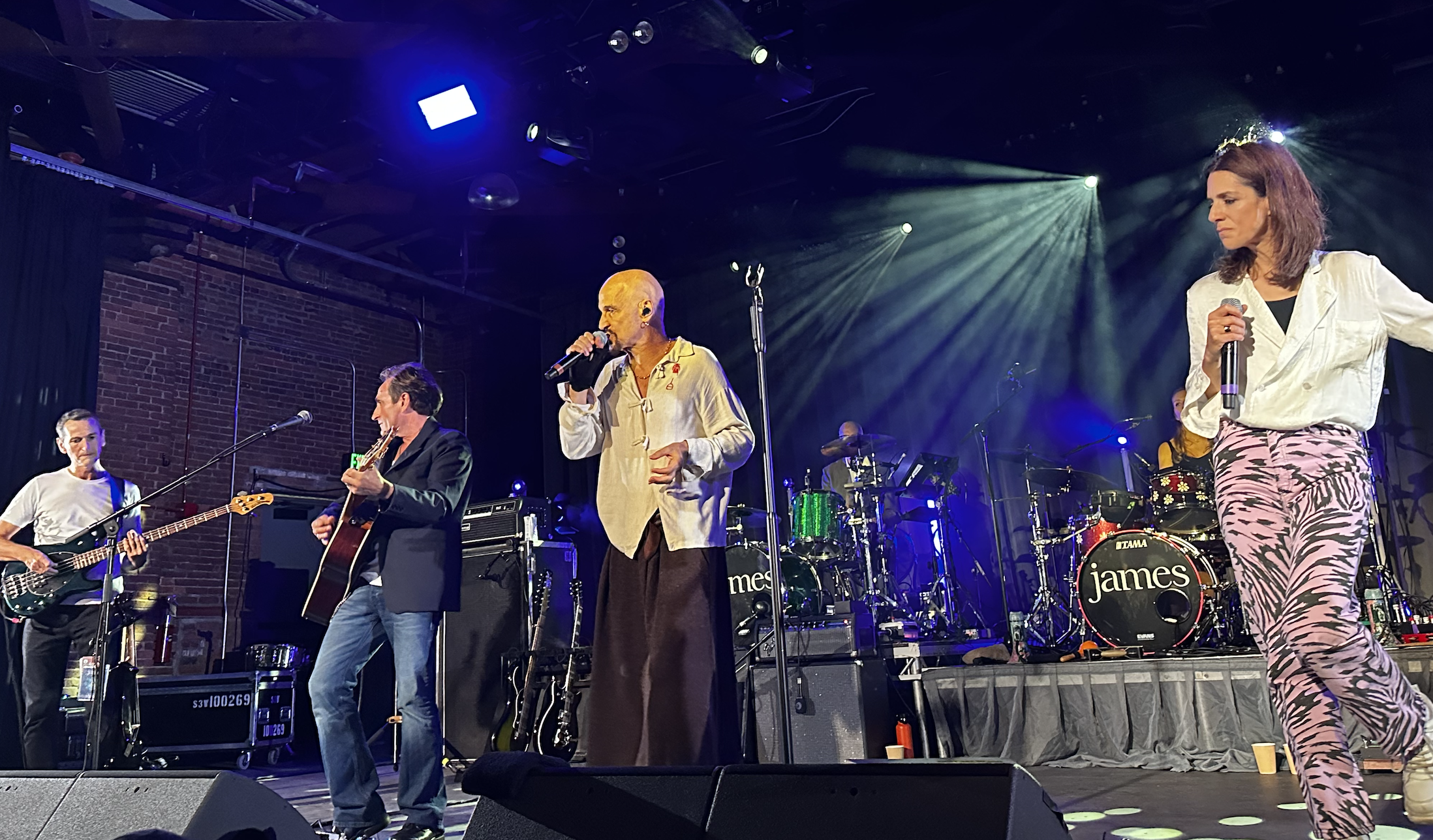 The bass player, guitar player, and two singers of the band James