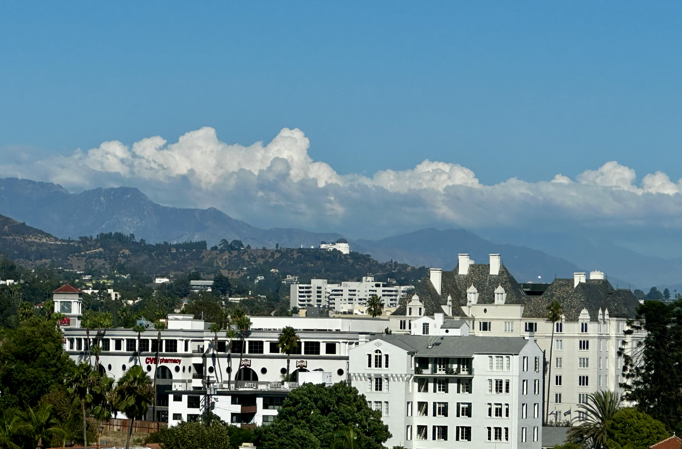 Photo looking east up the Sunset Strop, with the Chateau Marmont hotel in the foreground and Griffith Park Observatory and the mountains in the distance