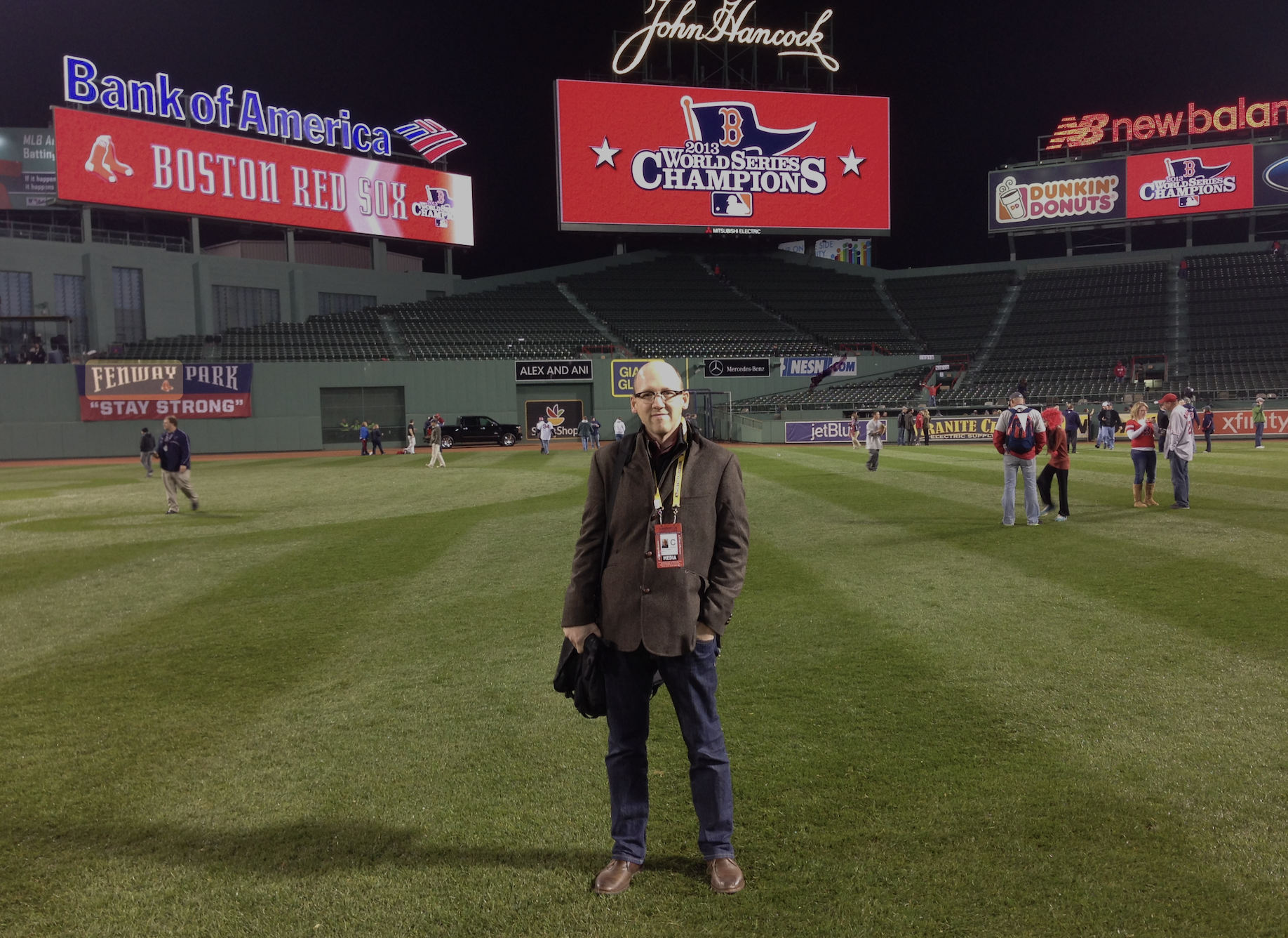 Me on the field at Fenway Park with the scoreboard showing "2013 World Series Champions" on it