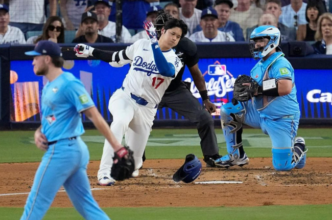 Trey Yesavage confidently walking off the field as Shohei Ohtani flails for strike three, one knee to the ground, pained look on his face, and his helmet flying off.