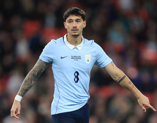 Player in a Team Uruguay kit that has two weird points on each of the shoulders