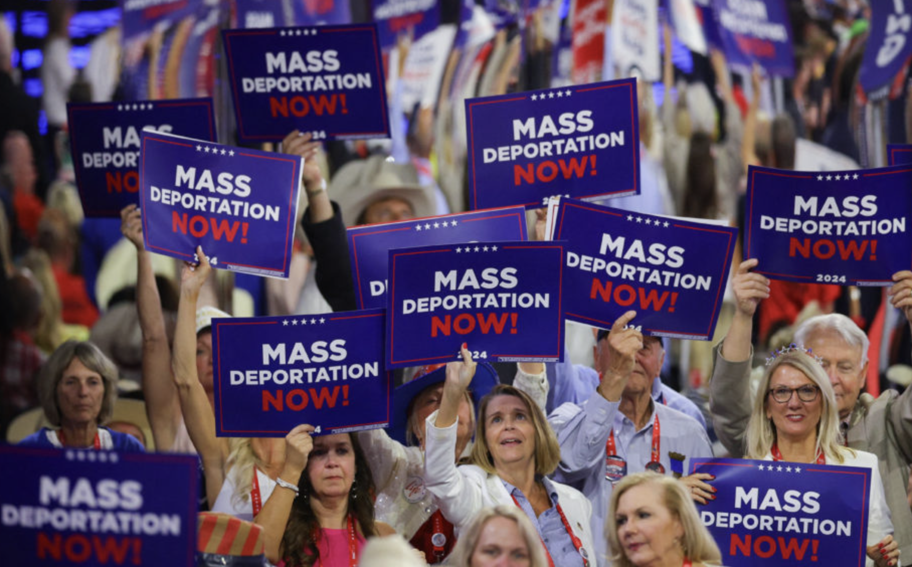 People at the 2024 GOP convention holding "MASS DEPORTATION NOW!" signs