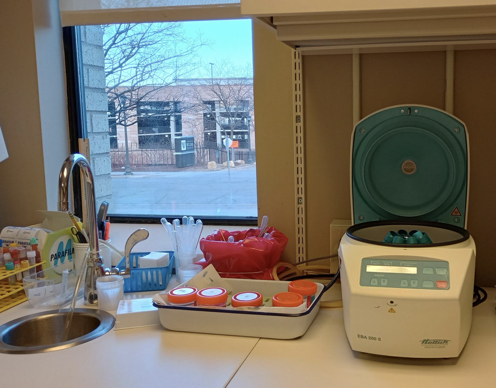 A medical lab, with a sink, centrifuge, test tubes, and stuff