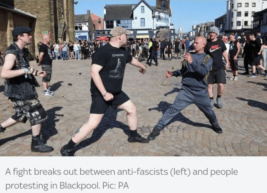 Photo of two men fighting on the street with the caption "A fight breaks out between anti-fascists (left) and people protesting in Blackpool"