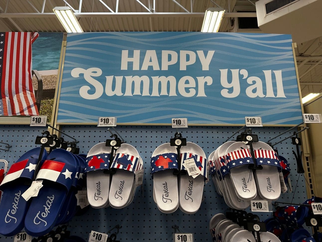 Texas flag-themsed flip flops that say "Texas" on the under a sign that says "Happy Summer Y'all"