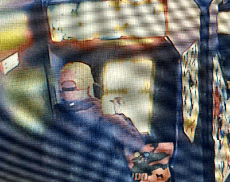 Security camera footage of a guy vandalizing a video game at an arcade